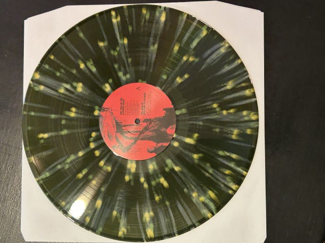 Murder of the Universe vinyl in dark green with bright yellow chunks